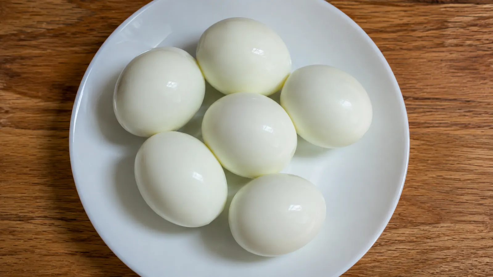 Plate of perfectly peeled hard-boiled eggs with smooth whites and no craters